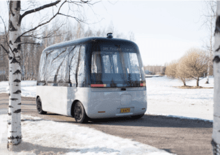 The first all-weather autonomous bus GACHA driving on a path in a wintery scene.