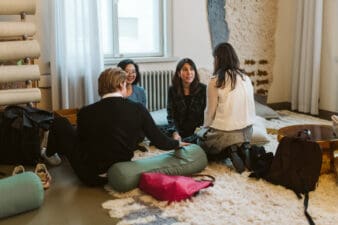 Diverse group of people sit on a floor at a business event
