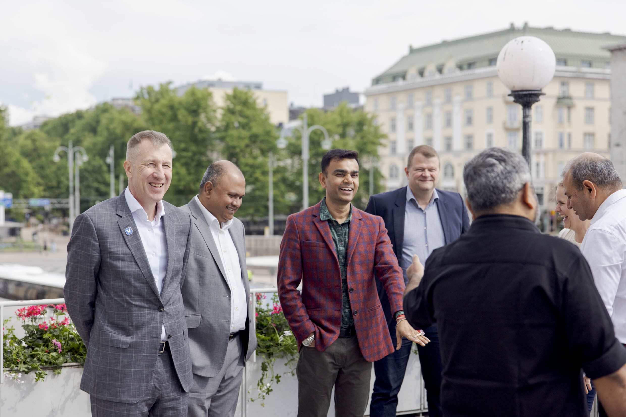 A group of men chatting and laughing together outside